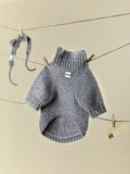 Main product view of the Sage Tweed alpaca-wool blend dog sweater with matching knitted bow tie hanging on a clothesline.