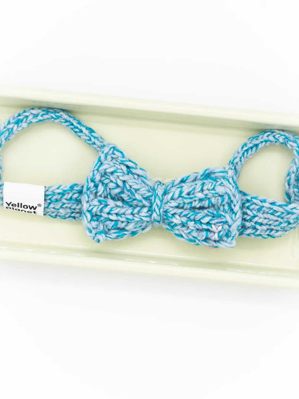 Close-up of the Azure Tweed knitted bow tie, showcasing the intricate blue and white flecked yarn texture.