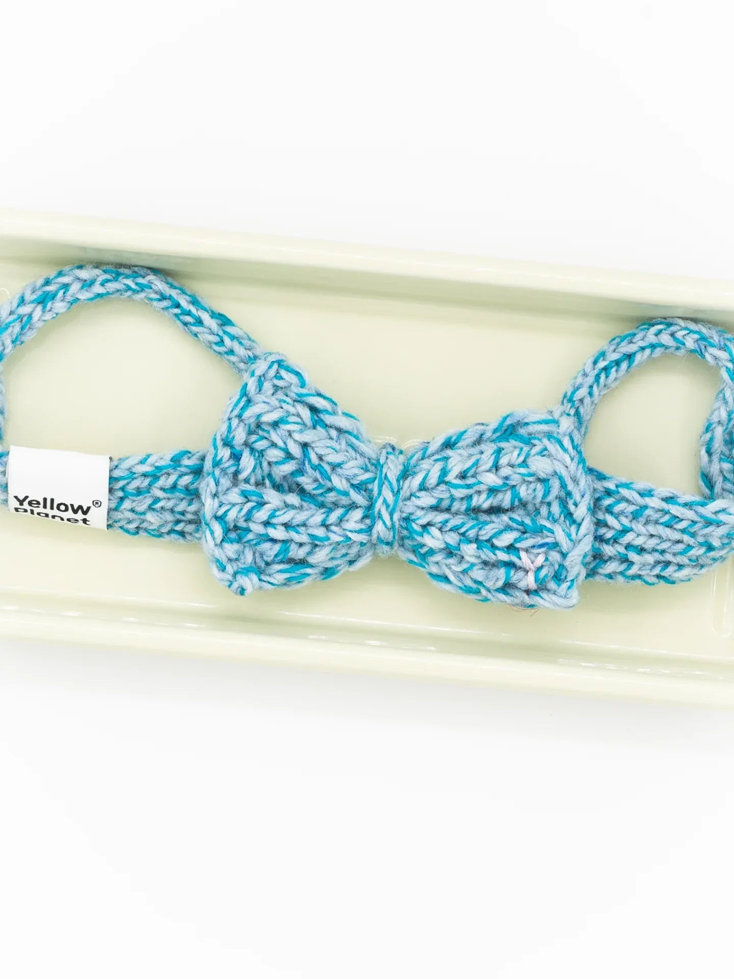 Close-up of the Azure Tweed knitted bow tie, showcasing the intricate blue and white flecked yarn texture.