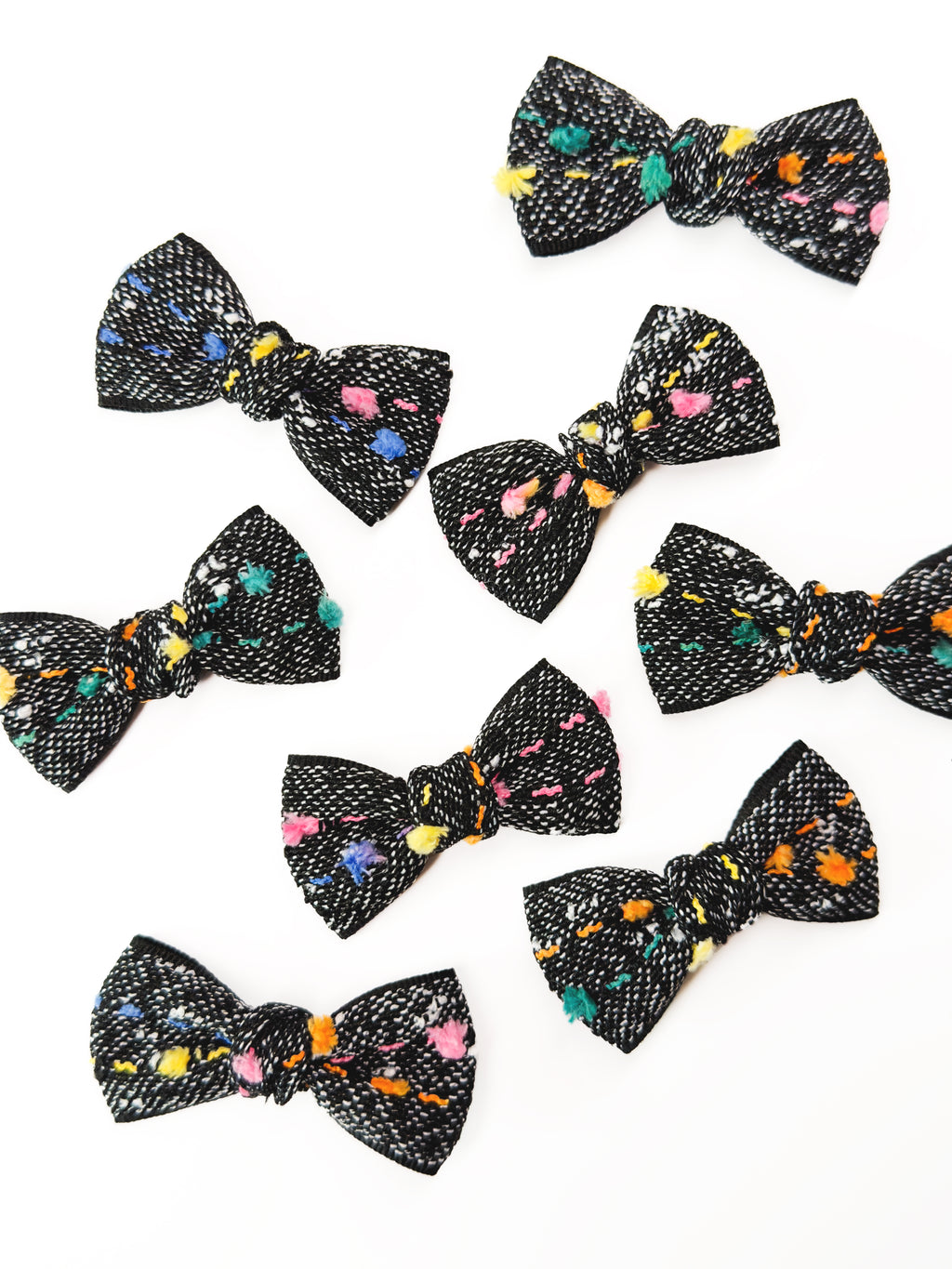 Collection of BALOVESYOU Crayon Confetti pet hair clips in assorted bow designs and sizes.