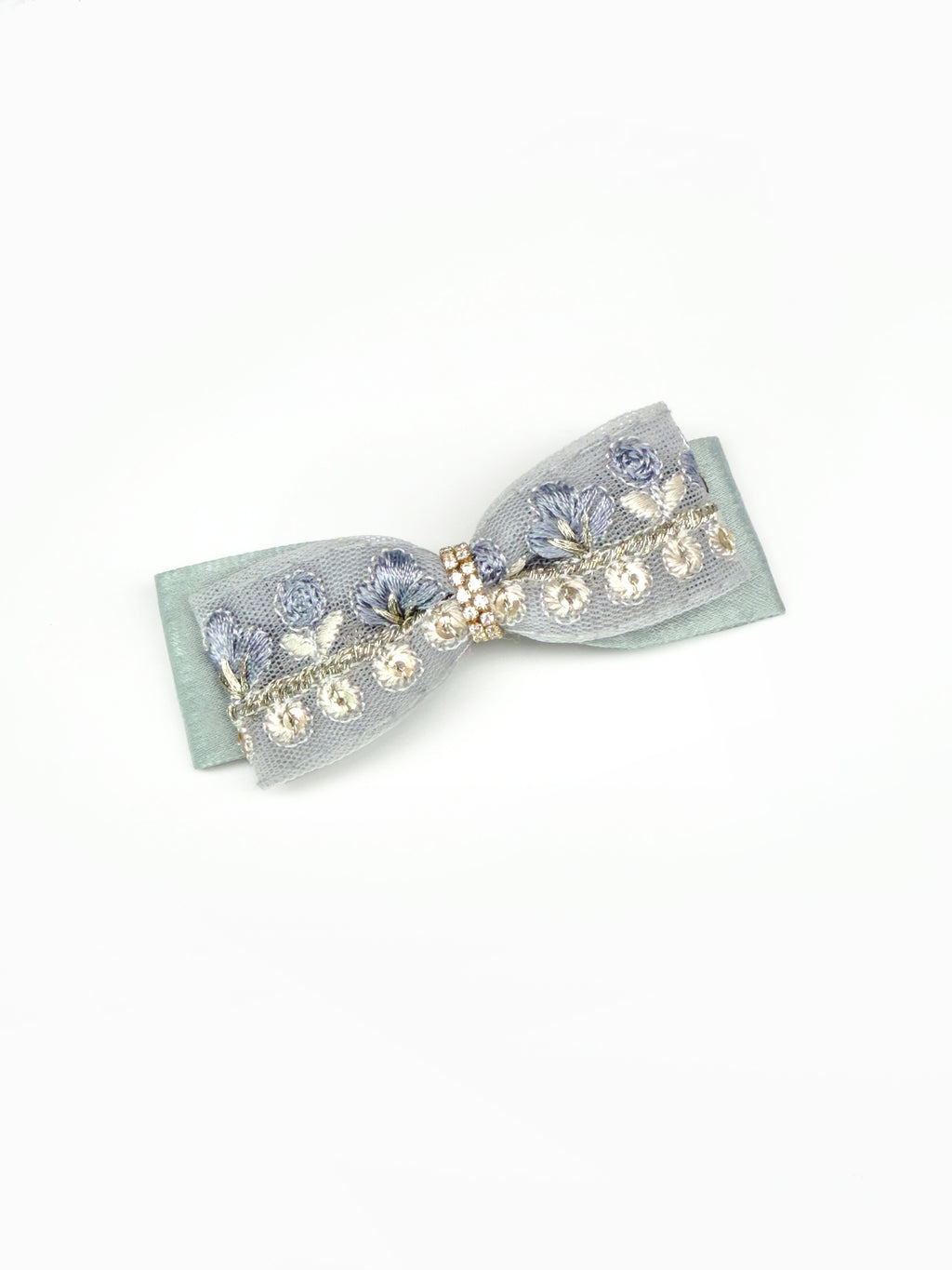 Flat lay of the BALOVESYOU Dawn Shimmer pet hair clip featuring a pale blue layered bow design.