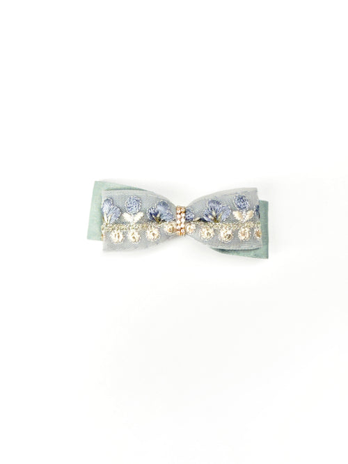 BALOVESYOU Dawn Shimmer pet hair clip with a pale blue bow, pearl embellishments, and soft layered details.
