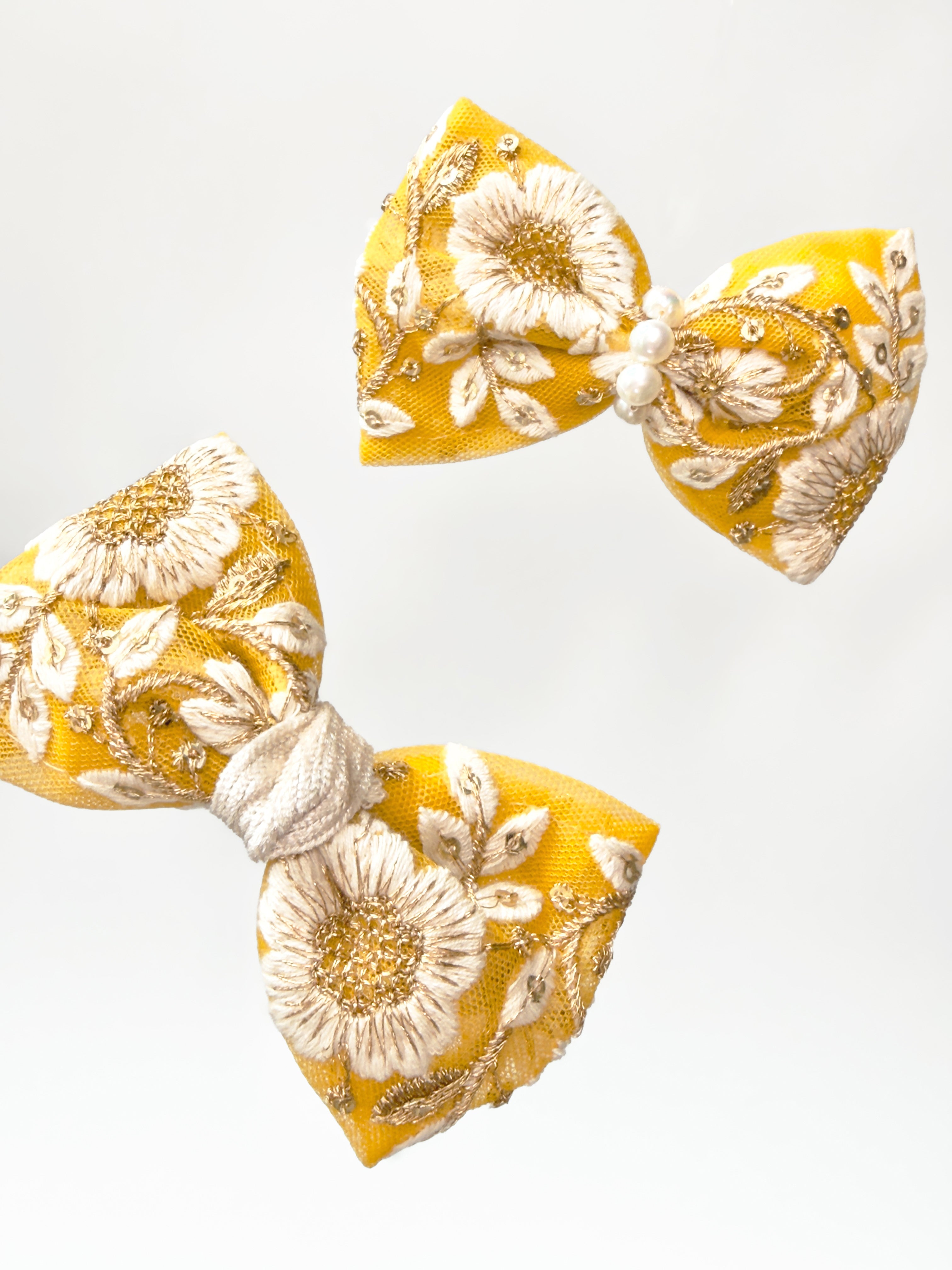 Flat lay of two BALOVESYOU Jardin Baroque pet hair clips in Perle with floral and pearl embellishments.