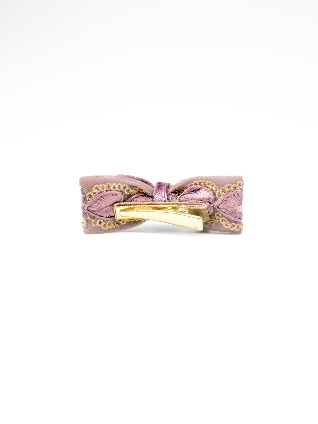 Detail view of the BALOVESYOU Smoky Rose pet hair clip in a slim flat lay composition.
