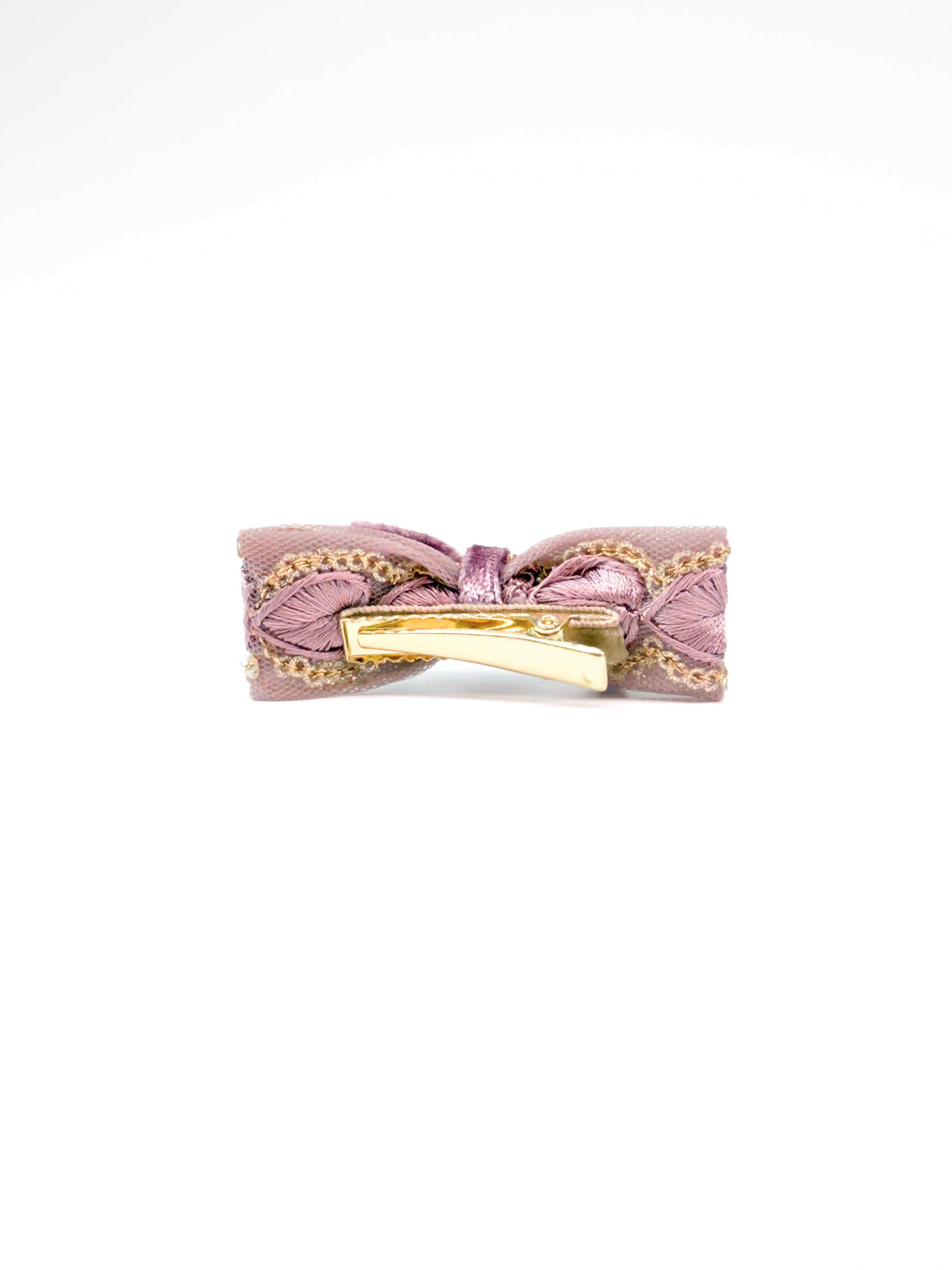 Detail view of the BALOVESYOU Smoky Rose pet hair clip in a slim flat lay composition.