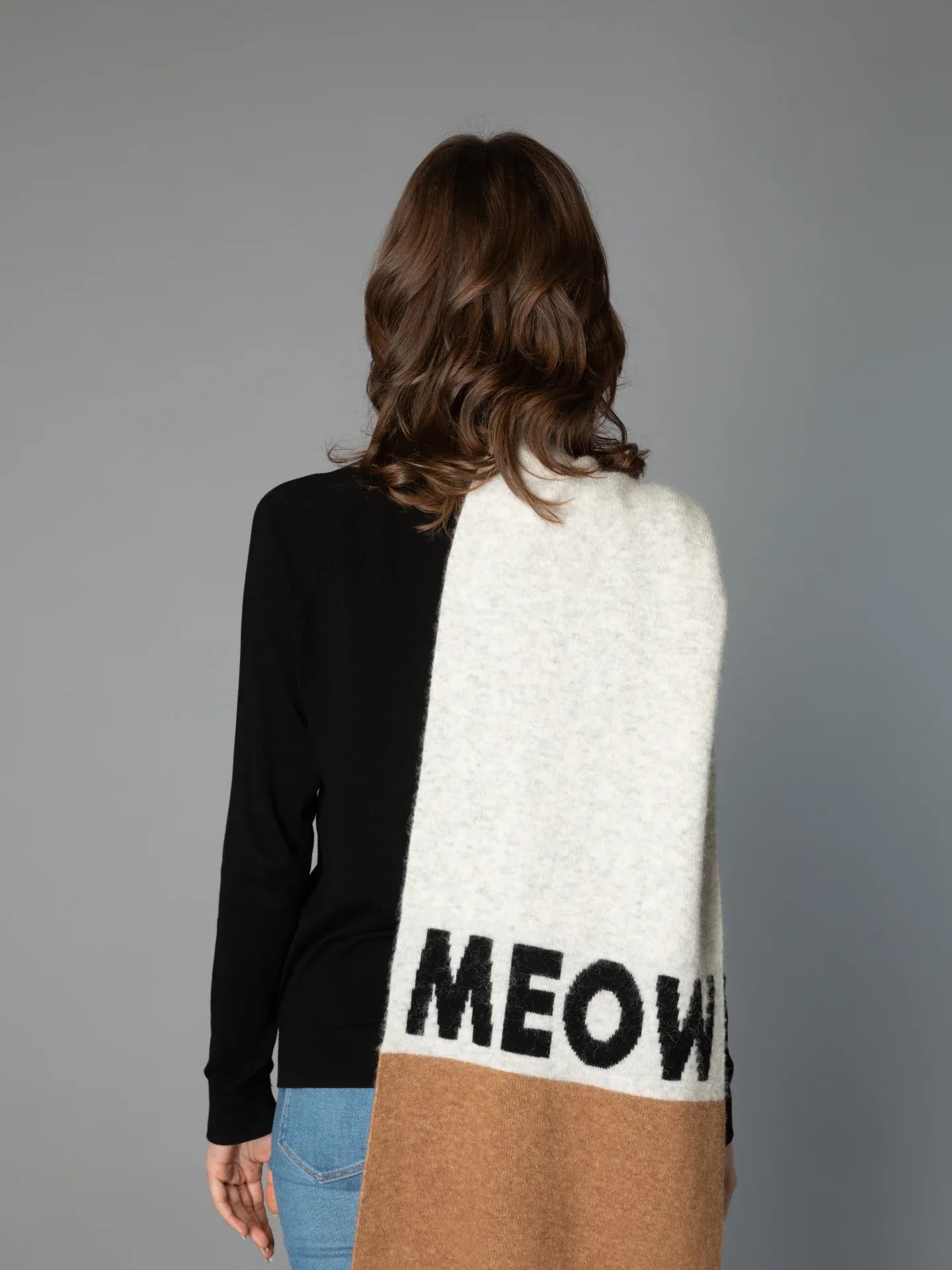 Back view of a woman modeling the CAT-Sophy "MEOW" theme oversized scarf in grey, brown, and blue-striped colorblock.