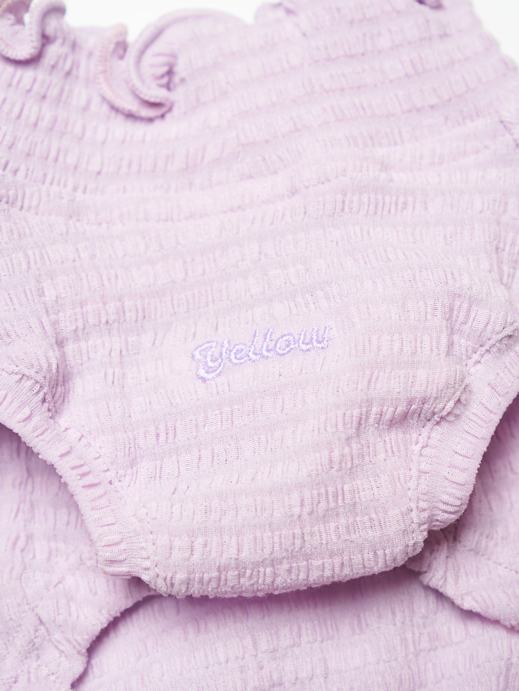 Close-up of the Purple wavy textured fabric and subtle logo detail on the Colorful Daily AIRWave Tank.