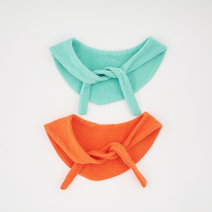 Flat lay of Colorful Daily Series pet bandanas in green and orange on white background
