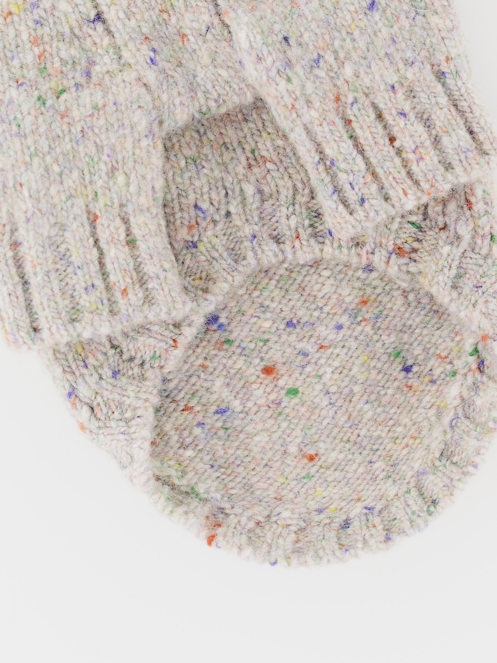 Detailed close-up of the hem/ribbing of the Confetti Cream gentle dog sweater, showcasing the tweed fabric and durable structure.