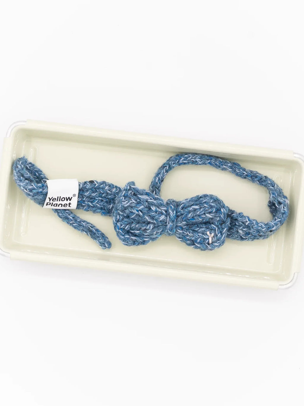 Top-down studio view of the Denim Tweed alpaca wool bow tie showing the adjustable knitted strap.