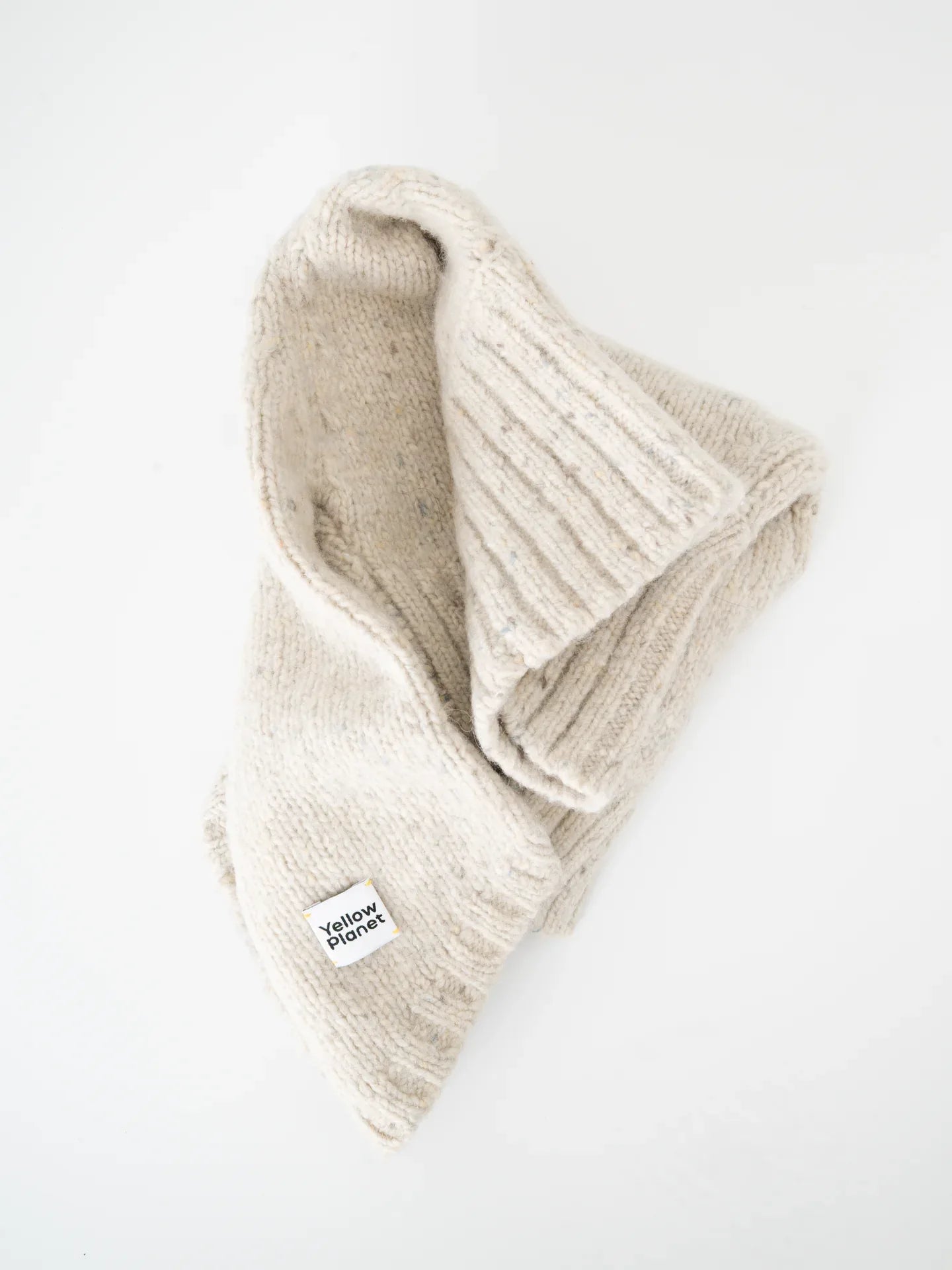 A top-down view of the Milk Tweed pet sweater folded to showcase the soft, thick alpaca wool material.