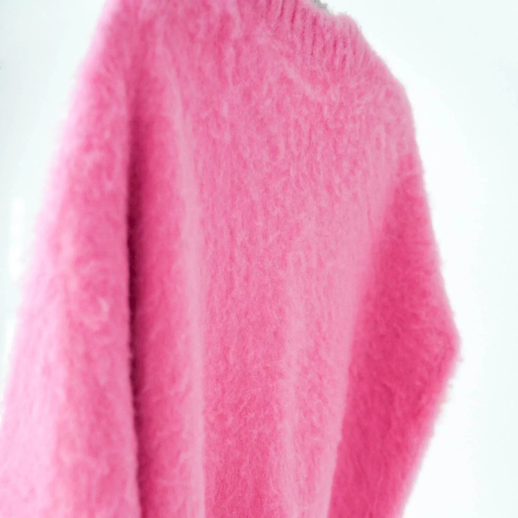 Extreme close-up of the vibrant pink mohair-style knit, highlighting the "Fuwa Fuwa" high-loft fuzzy texture and softness.
