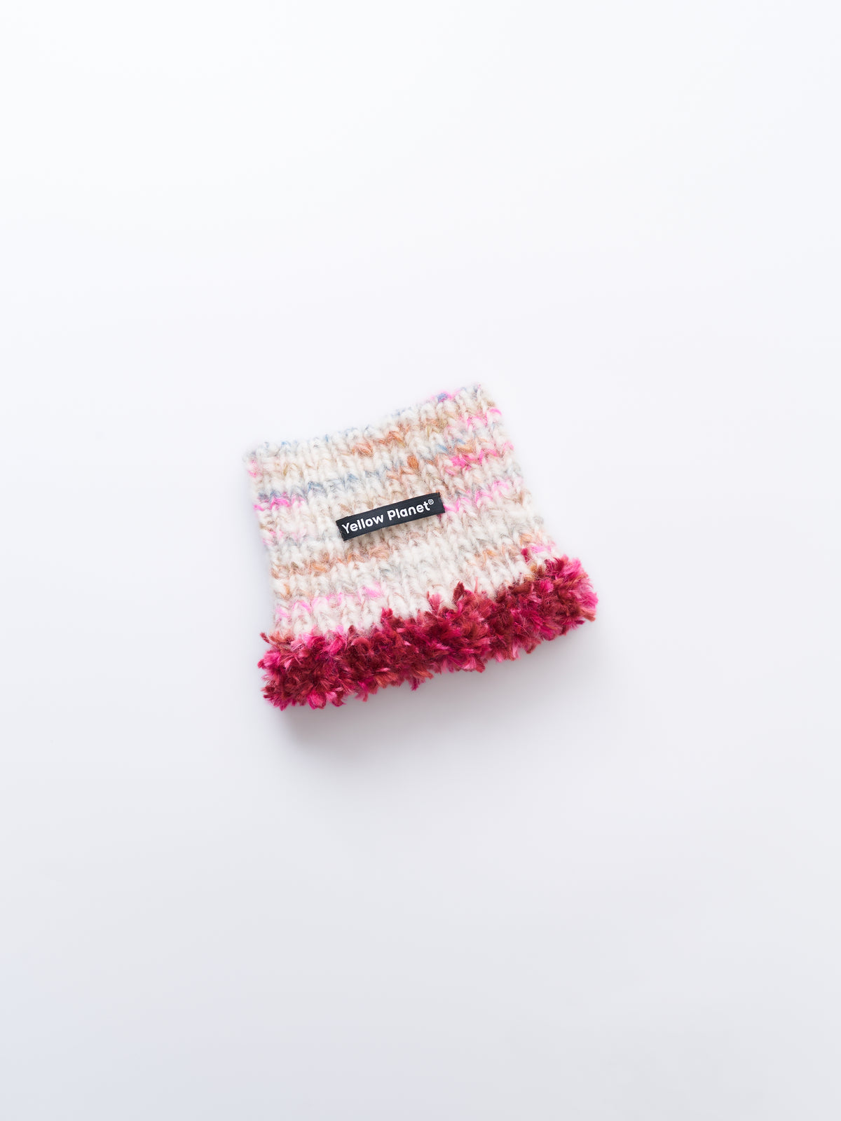 Main studio shot of the limited edition "camellia rose" hand-knitted luxe pet snood in cream speckled wool with wine red fringe tassels.