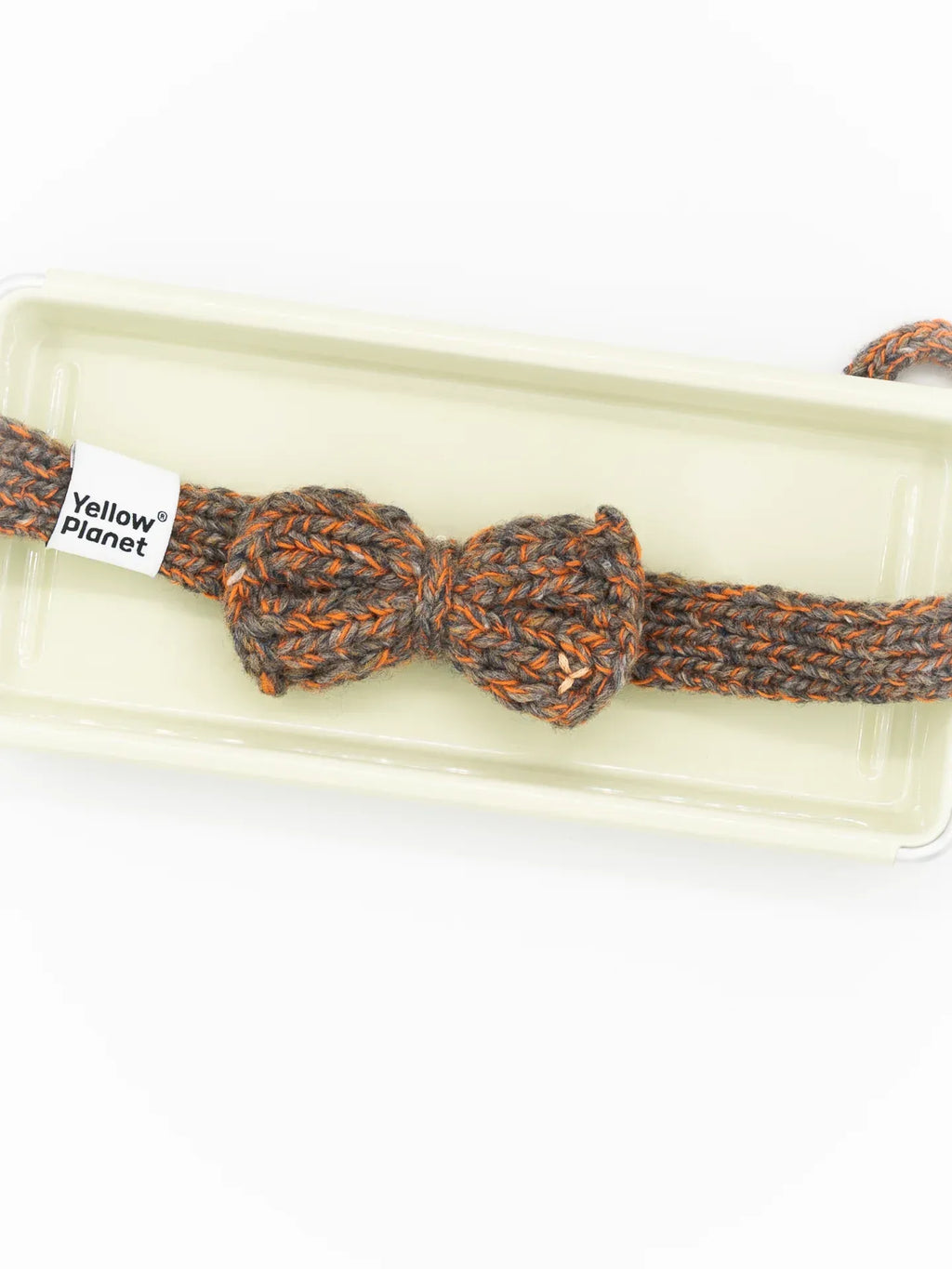 The Rust Tweed bow tie presented in minimalist, eco-friendly boutique packaging with a "Yellow Planet" brand label.