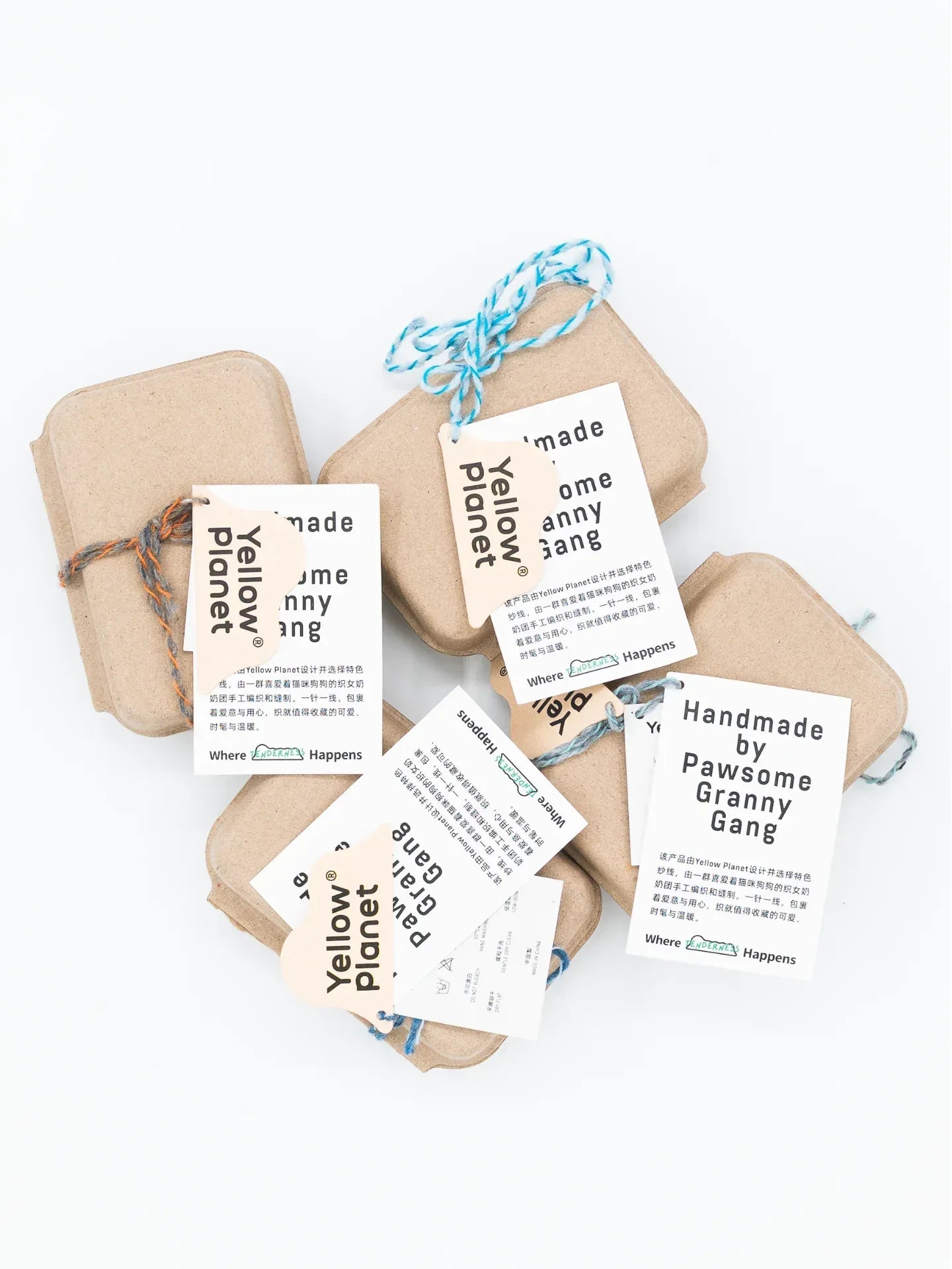 Sustainable craft paper gift packaging with minimalist tags for the Funky Gentle Dog Series hand-knitted accessories.