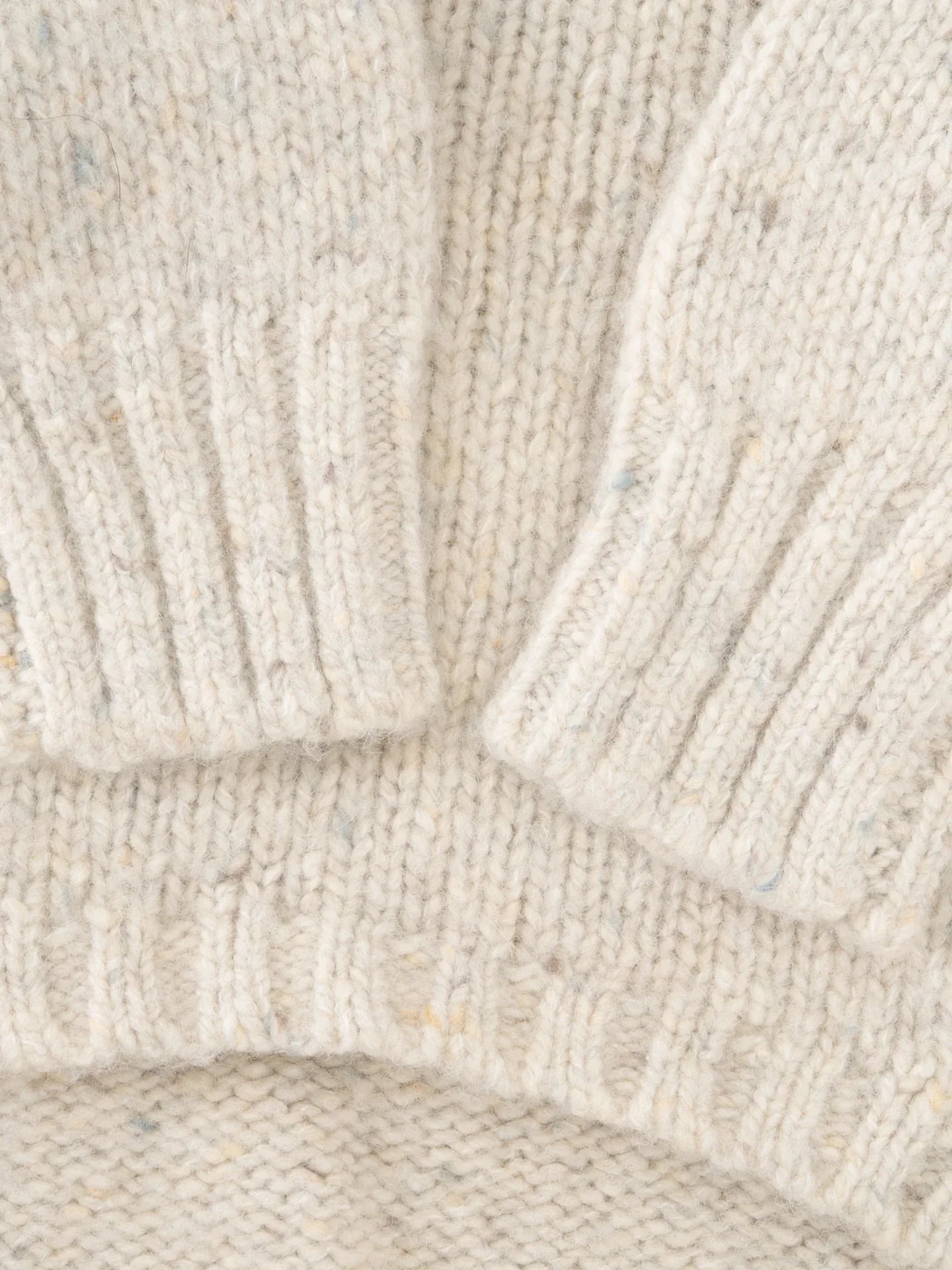 Close-up of the ribbed sleeve cuffs on the Milk Tweed dog sweater, highlighting the high-quality knit construction.