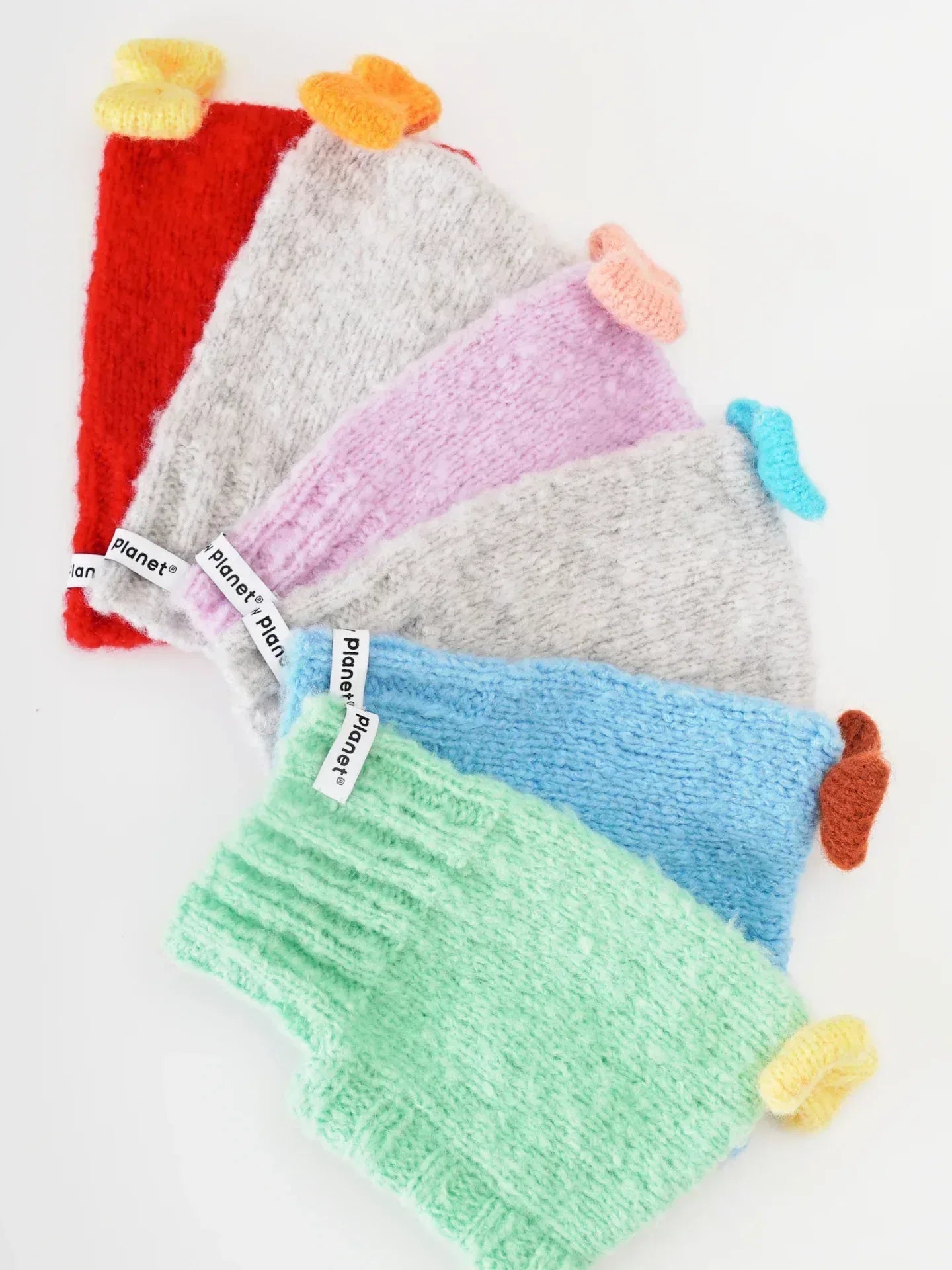 A collection shot showcasing the "Mochi BonBon" beanie in red, grey, purple, blue, and green colorways.