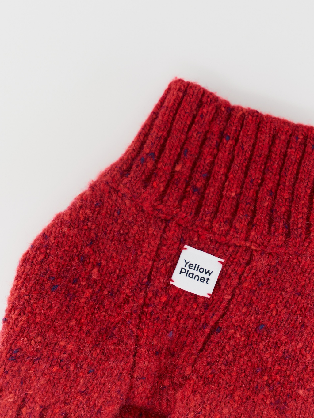 Close-up of the Mulled Wine gentle dog sweater collar and chest, clearly showing the rich tweed texture and the Yellow Planet logo.