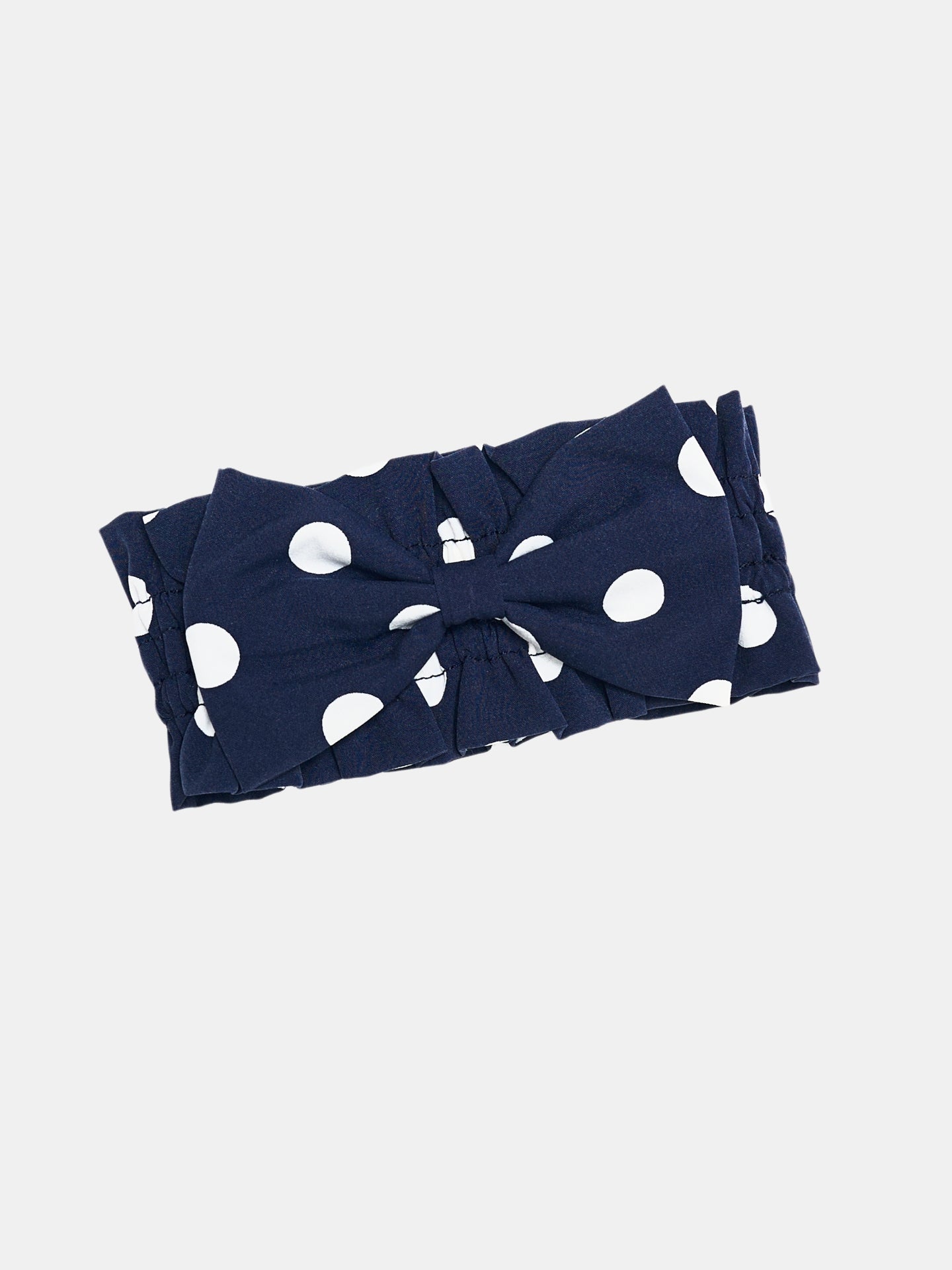 Oasis Polka Dot Bow Neckpiece in Navy with white polka dots and a soft bow, inspired by vintage European collar styling.