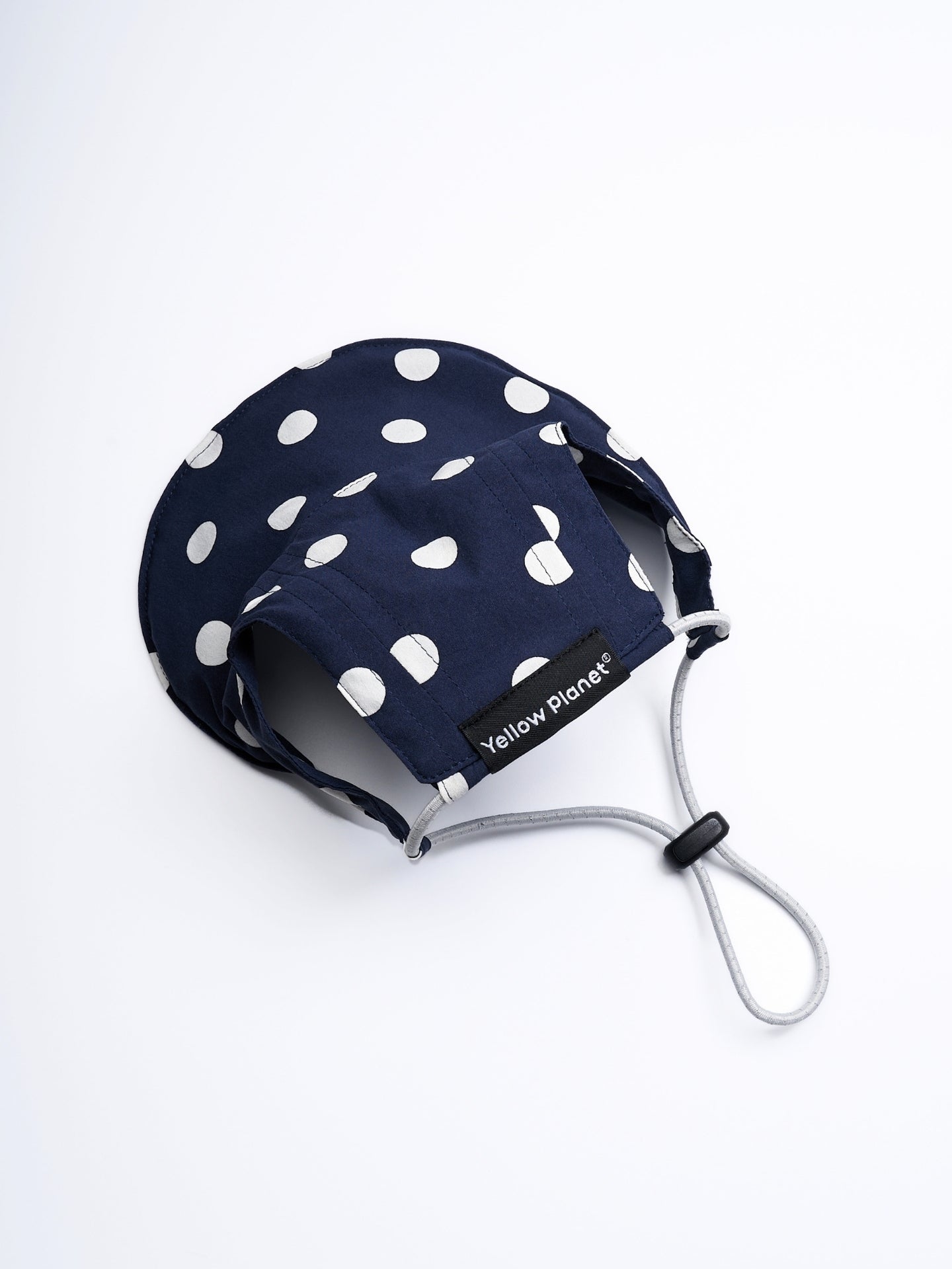 Rear view of the Oasis Polka Dot UV Pet Cap in Navy with ear openings, reflective elastic cord, and adjustable YKK cord stopper.