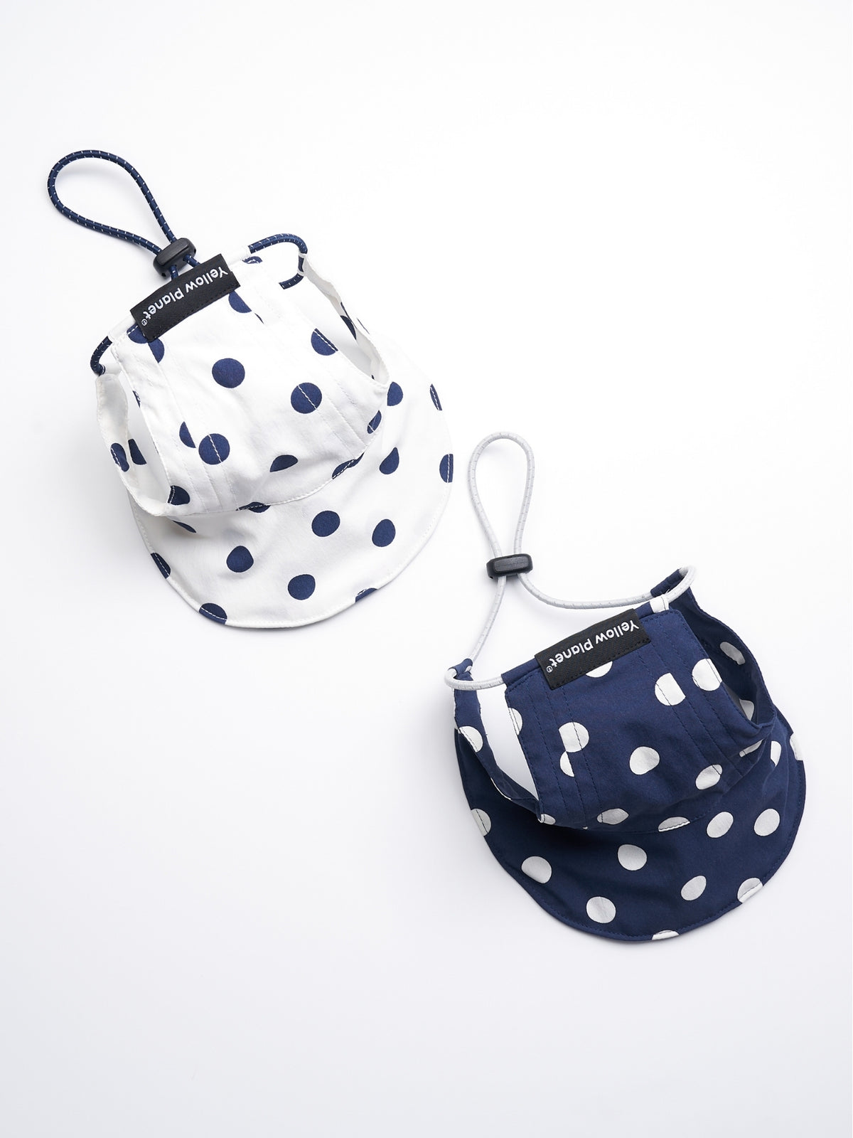 Oasis Series Polka Dot UV Pet Caps in White and Navy, showing the two available color options and adjustable cords.