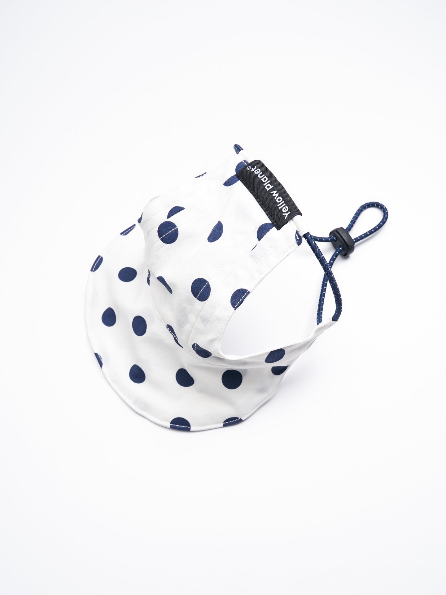 Rear view of the Oasis Polka Dot UV Pet Cap in White with ear openings, reflective elastic cord, and adjustable YKK cord stopper.