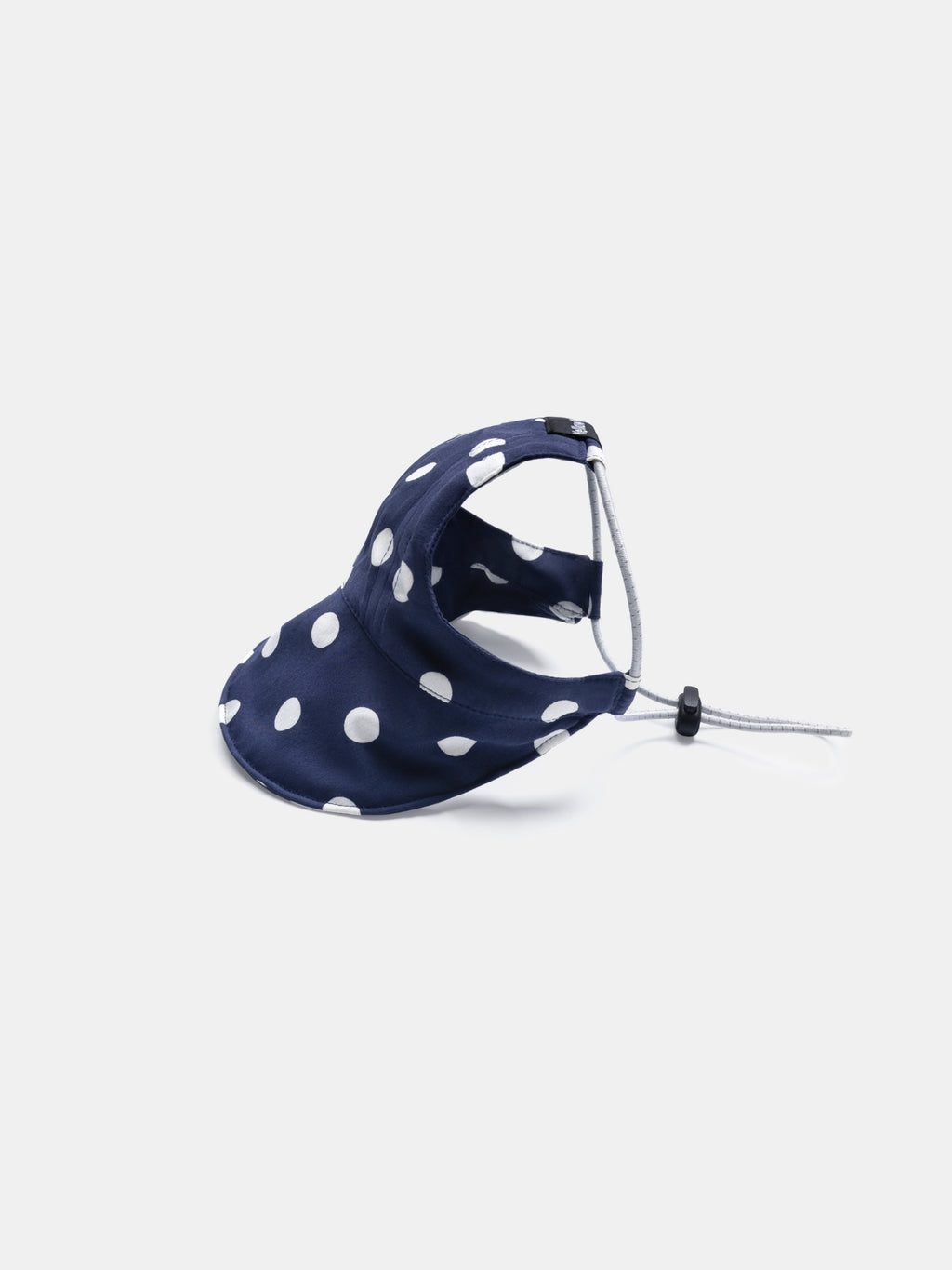 Side view of the Oasis Series Polka Dot UV Pet Cap in Navy with an adjustable brim and reflective elastic cord.