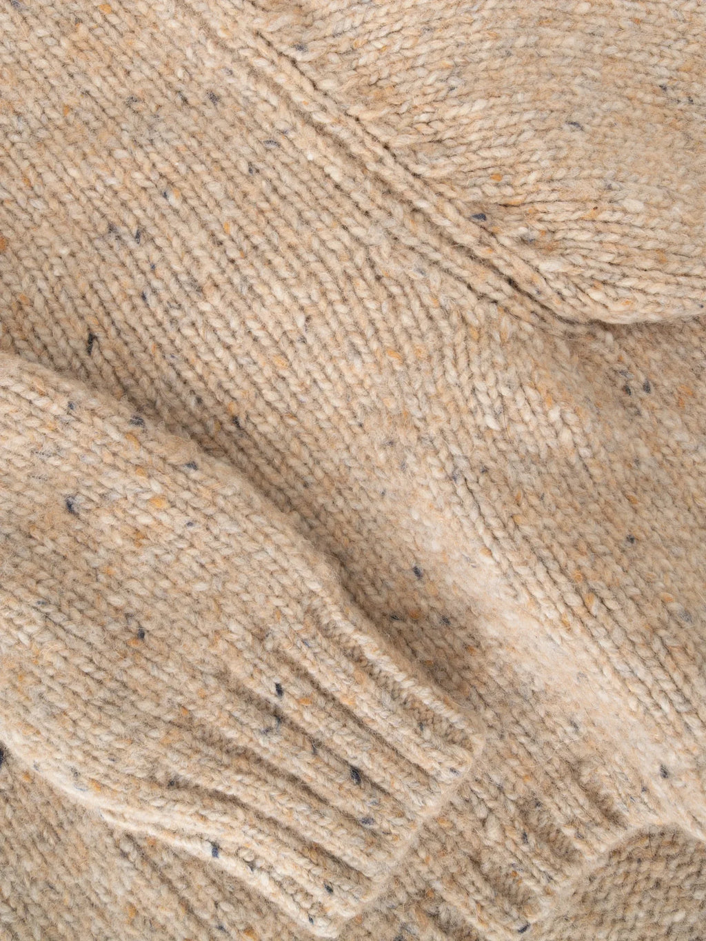 Close-up of the Oat Tweed fabric, showcasing the soft alpaca-wool blend with multi-colored tweed flecks.
