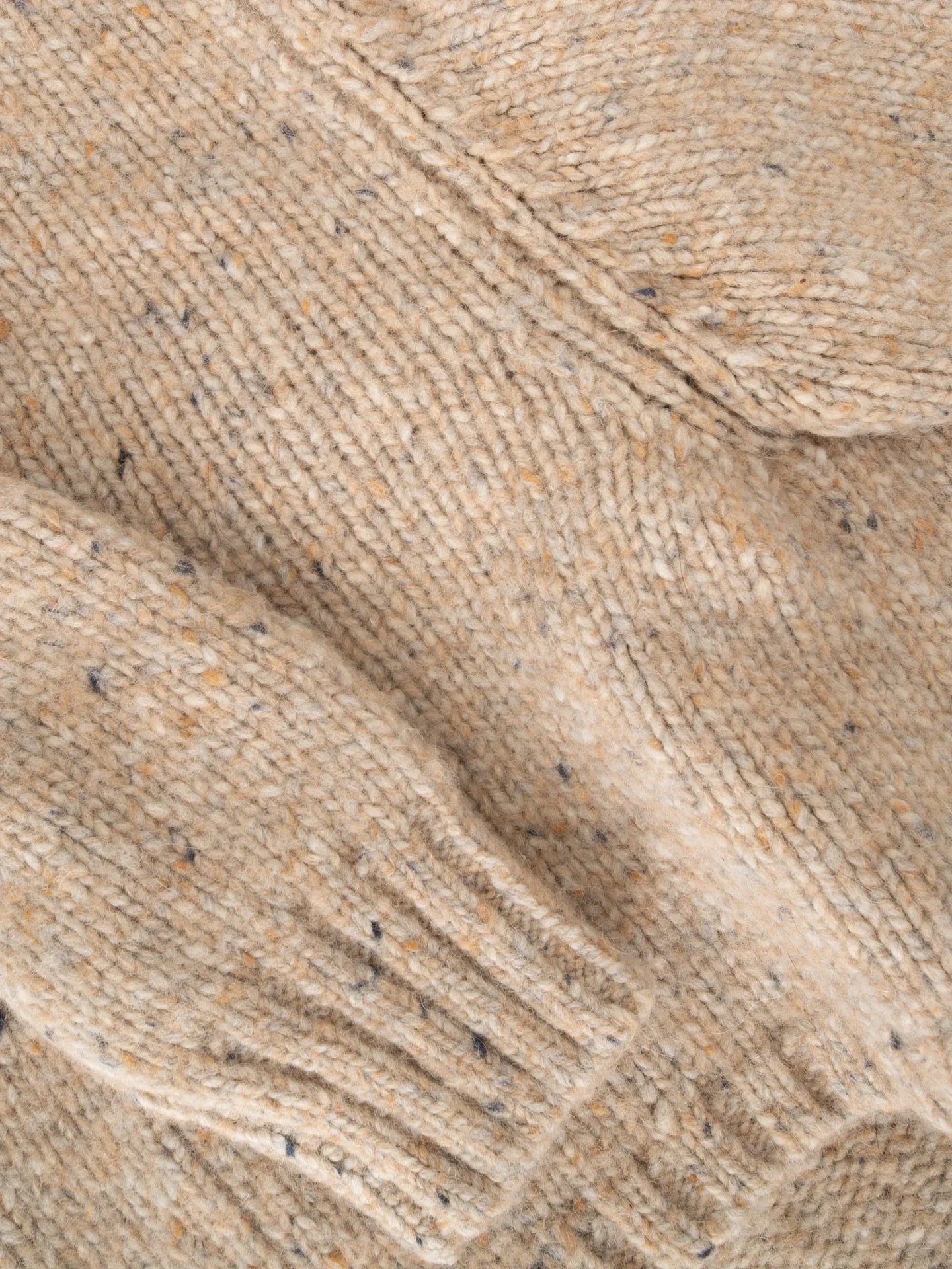 Close-up of the Oat Tweed fabric, showcasing the soft alpaca-wool blend with multi-colored tweed flecks.