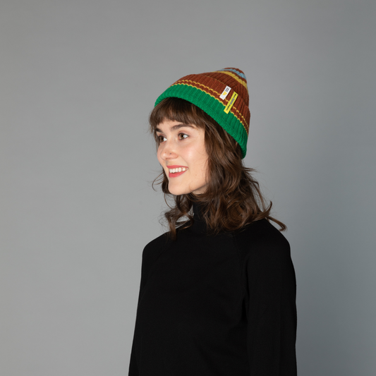 side view of human model wearing striped wool beanie