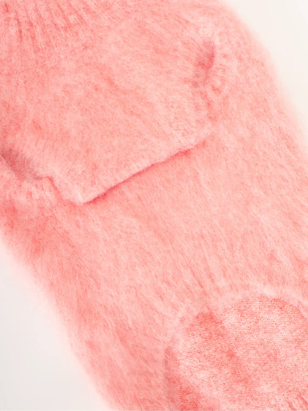 Detailed shot of the shoulder and armhole construction of the Pink Pear brushed knit vest for pets.