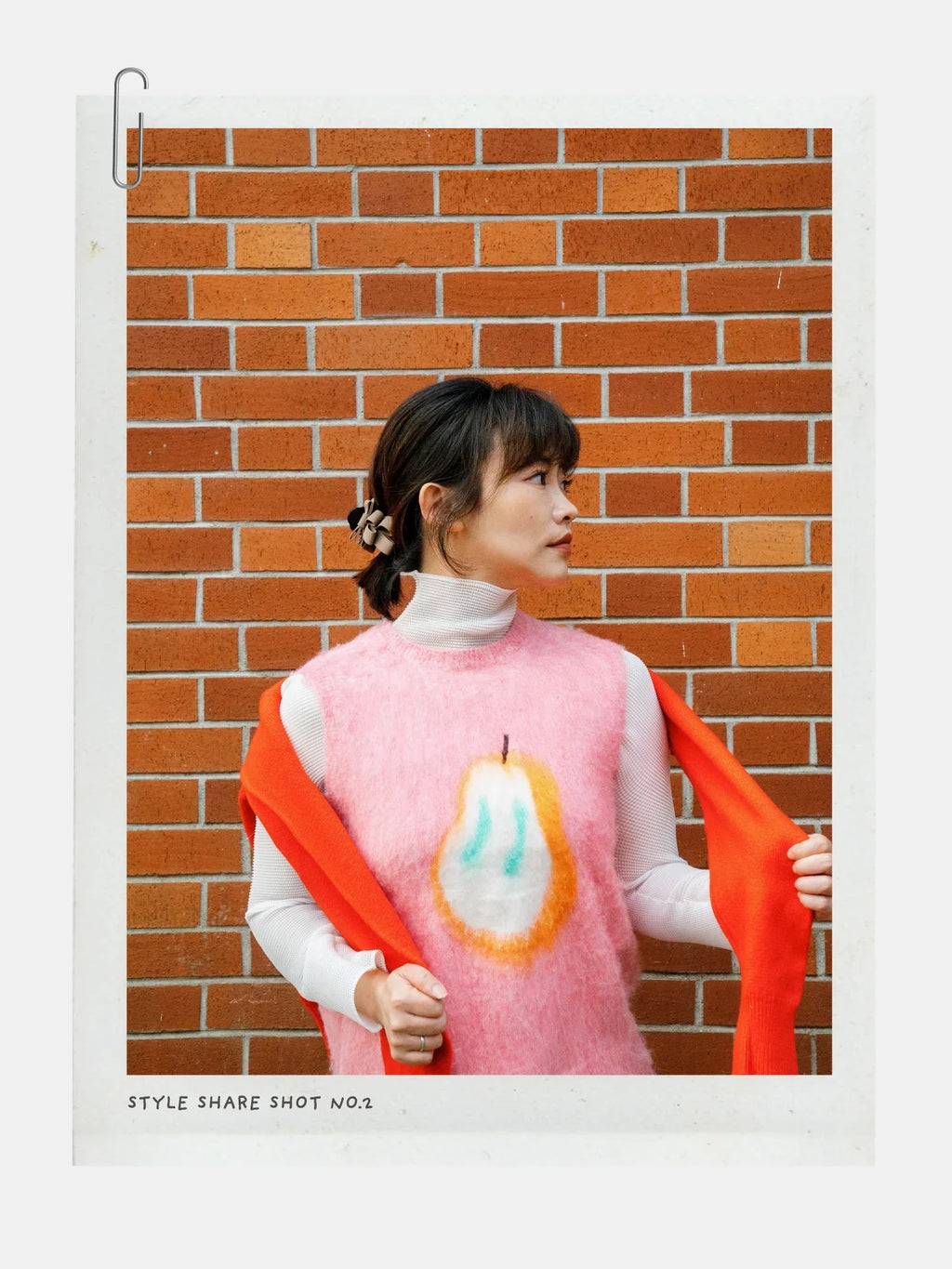 Full shot of a model wearing the Pink Pear brushed knit vest with light-colored pants, posing playfully, demonstrating the vest's fit.