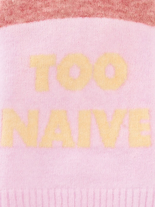 Close-up of the "TOO NAIVE" butter yellow typography on the pink alpaca wool knit fabric.